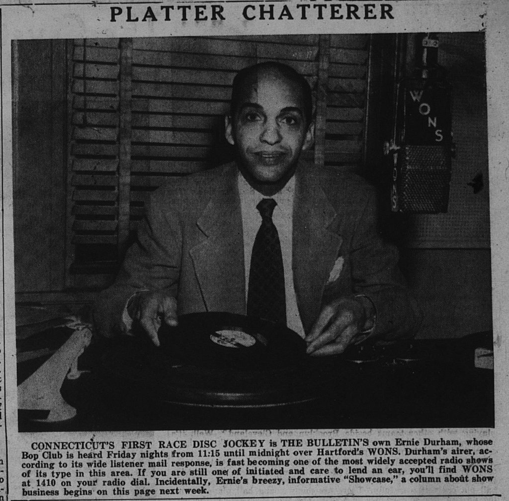 A photo of Ernie Durham, Connecticut's first "Race" Disc Jockey at his turntable. 